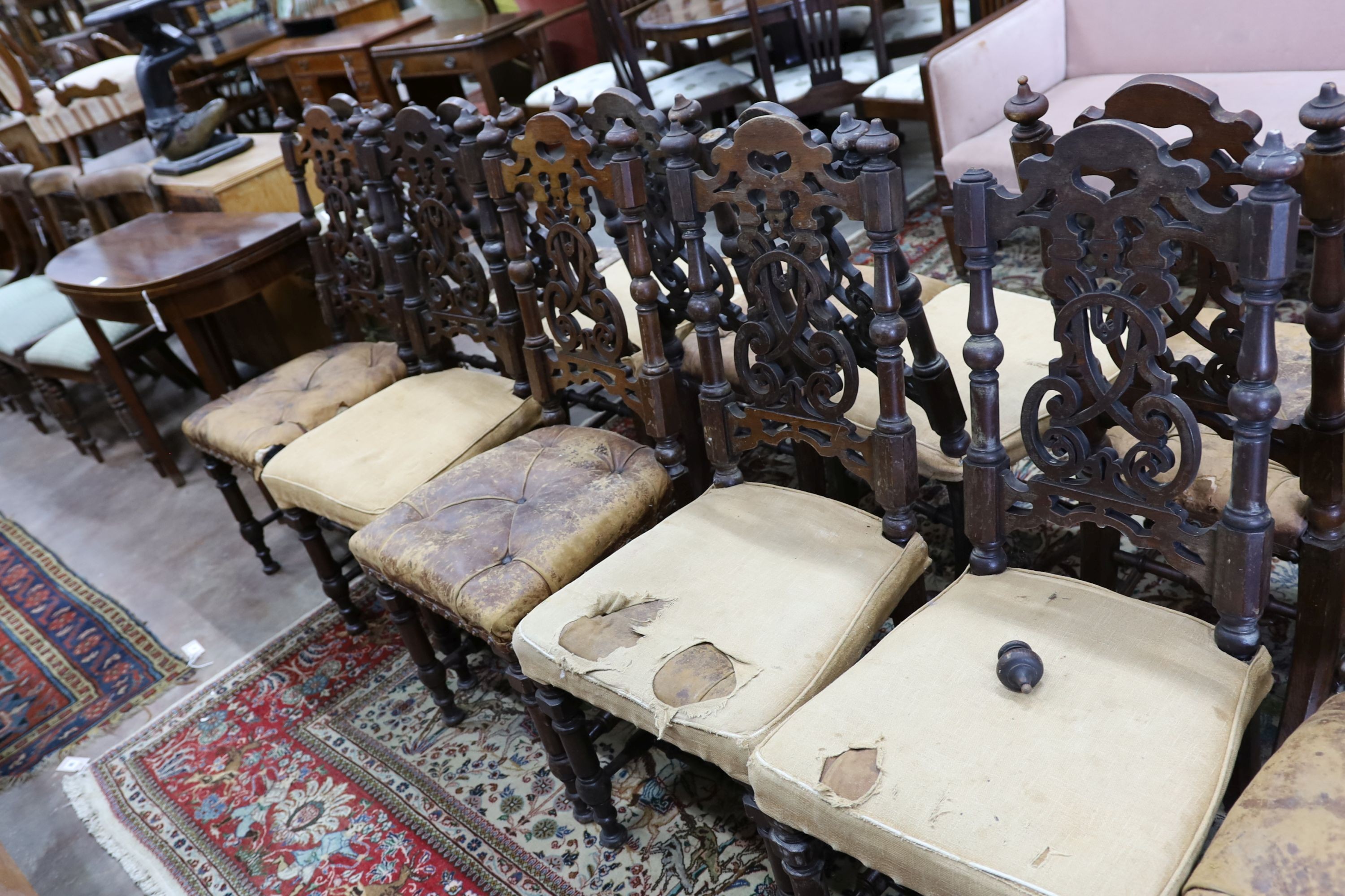 A set of fourteen 19th century Continental carved oak dining chairs